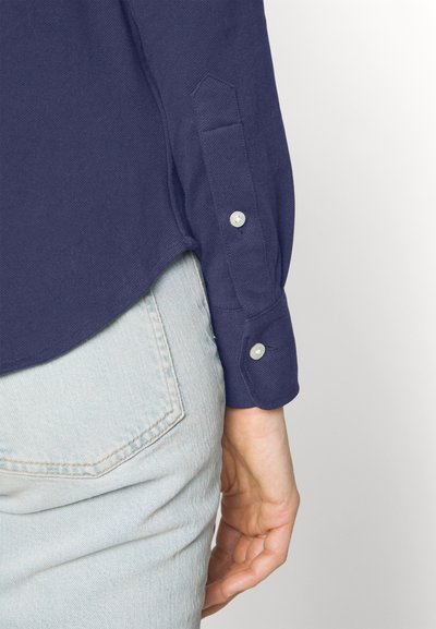 RL – Women's button-down shirt